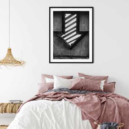 Illuminated Geometric Down Arrow on Textured Concrete Wall Black and White Print