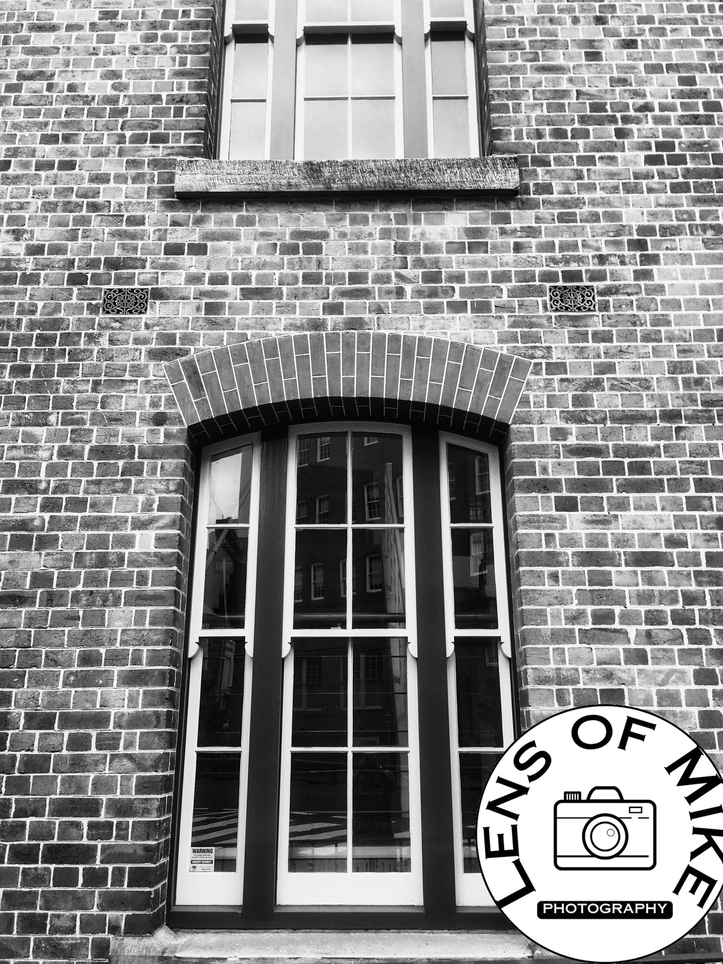Vintage Arched Sash Windows on Brick Facade Black and White Print
